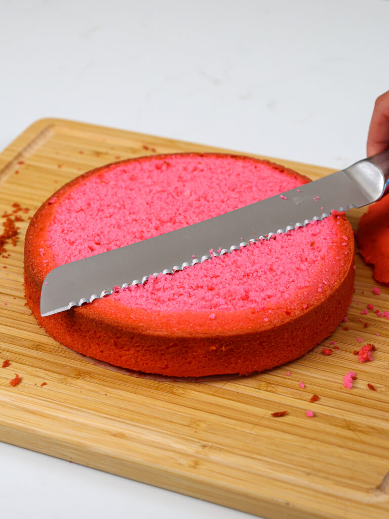 image of a hot pink cake layer that's been leveled with a serrated knife